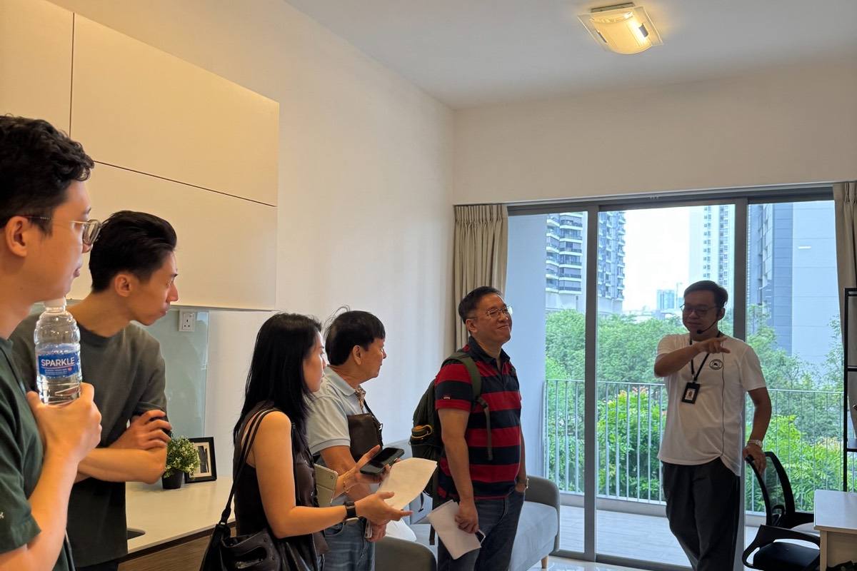 A Crestbrick agent walking clients through a residential unit on a viewing